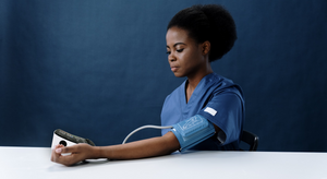 Nouvique Australia - Nurse taking Blood Pressure Monitor reading of herself