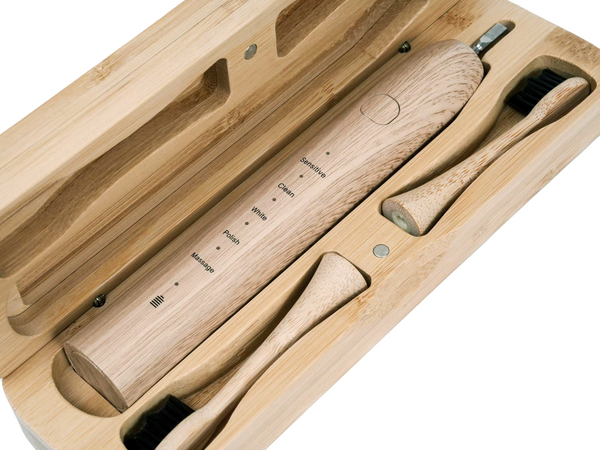 A diagonal birds eye view of a bamboo electric toothbrush case which has a bamboo electric toothbrush and tooth brush head instilled in the eco friendly case