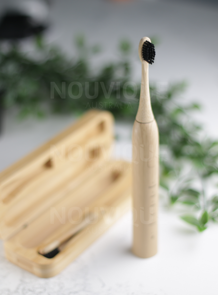 eco electric toothbrush is standing upright and focusing on the black bristles on the bamboo toothbrush head